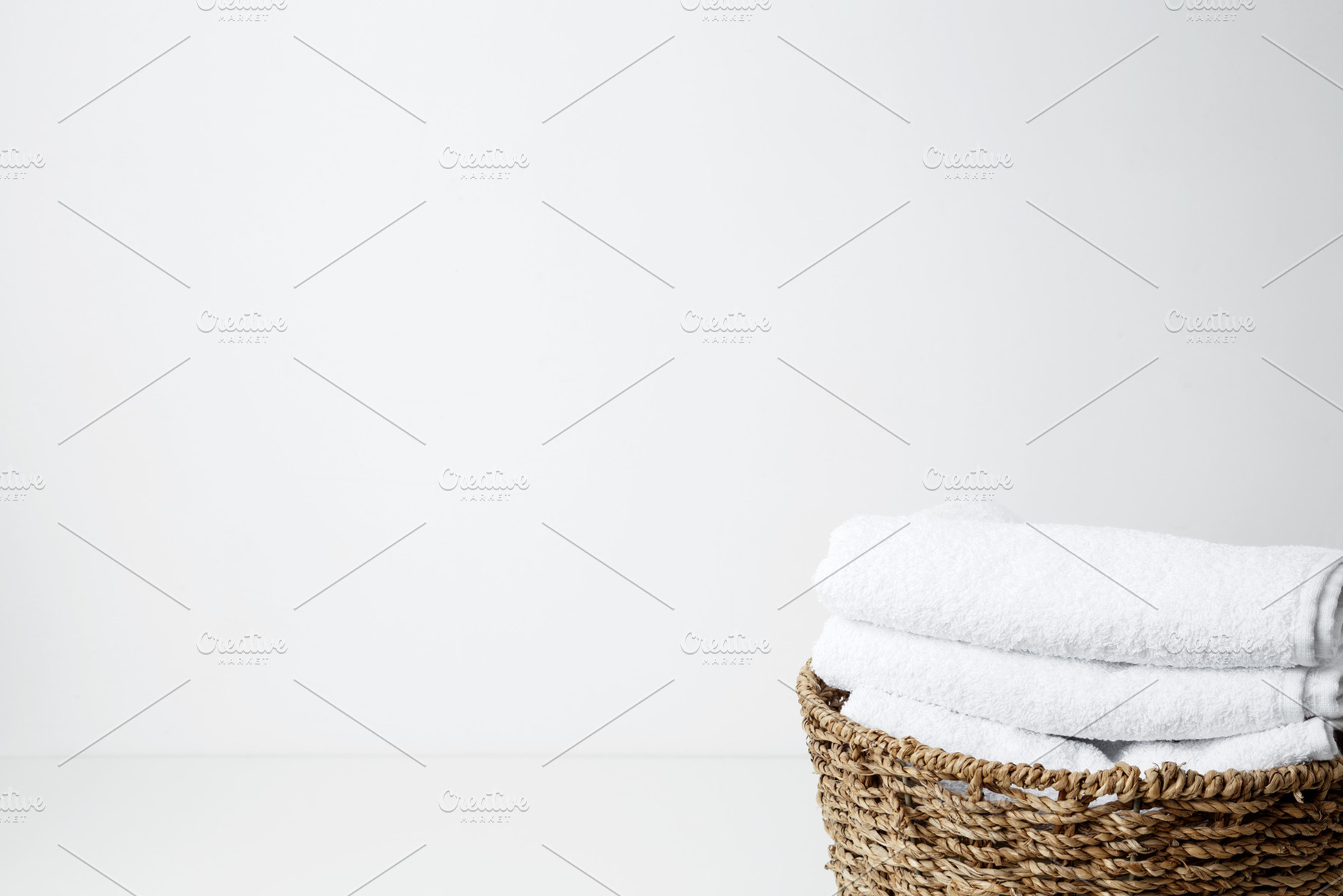 Basket filled with clean white towels in a neat arrangement. Household cleaning, a Photo by matucha