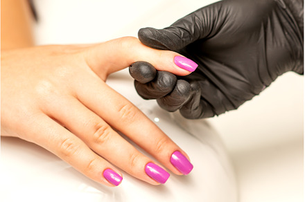 A manicurist holds beautiful young, a Beauty & Fashion Photo by okskukuruza