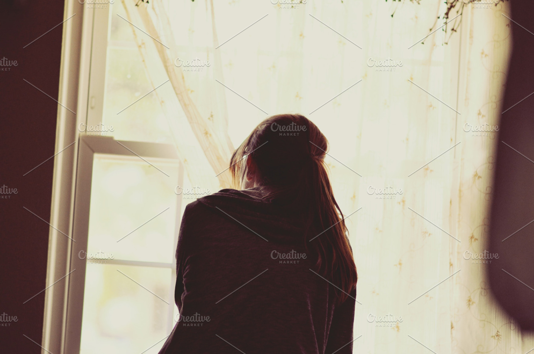 Woman peering out window