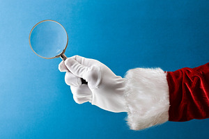 Santa Claus holding magnifying glass isolated on blue background, a Holiday Photo by Davizro's Market