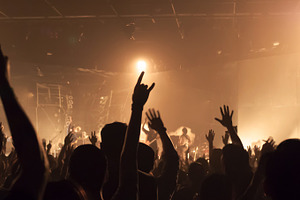 Music band crowds raising hands up in the air (very shallow depth of field)