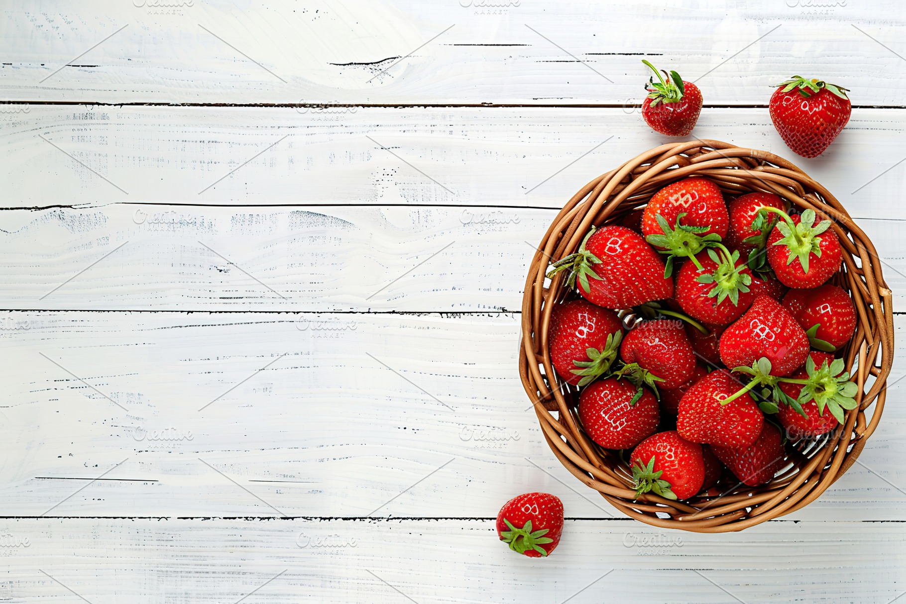 Red strawberries in basket on wooden table, a Food & Drink Photo by AlyaAnd