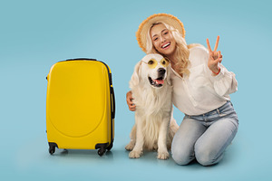Portrait of happy lady in summer hat hugging dog in colorful sunglasses, sittin, a Photo by Prostock-Studio