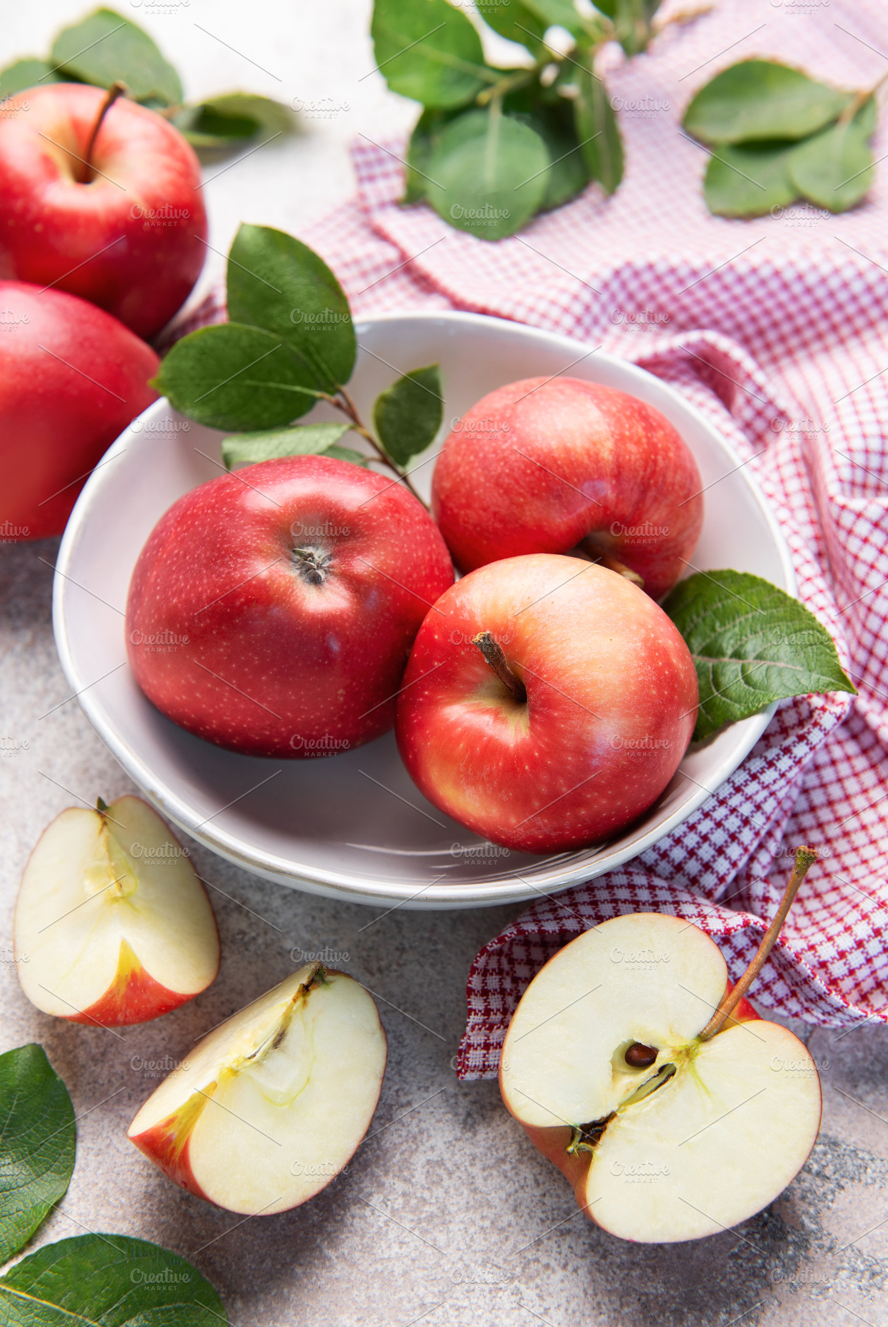 Fresh red apples in white bowl on table, a Food & Drink Photo by Olena Rudo
