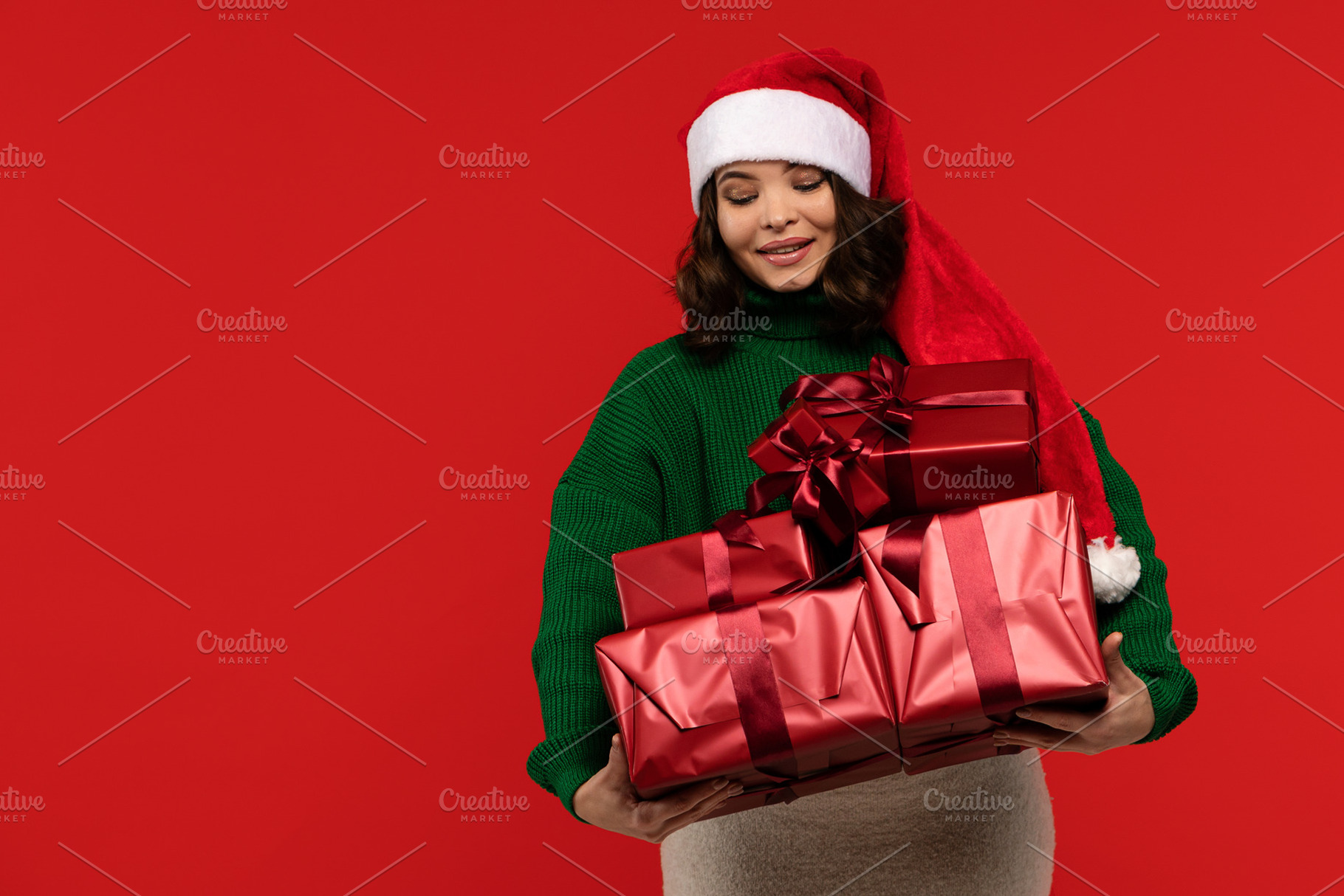 Woman looking down at gifts, a Holiday Photo by Elena Vagengeim