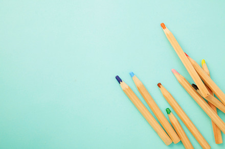 Colorful pencils on pastel pale blue, a Background Photo by 1981 Rustic studio kan