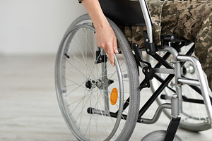Cropped Shot Of Female Soldier Sitting In Self-Propelled Manual Wheelchair, a Photo by Prostock-Studio