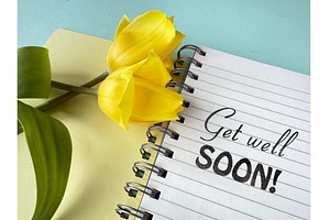 Yellow tulips on a notebook with, a Photo by tilialucida