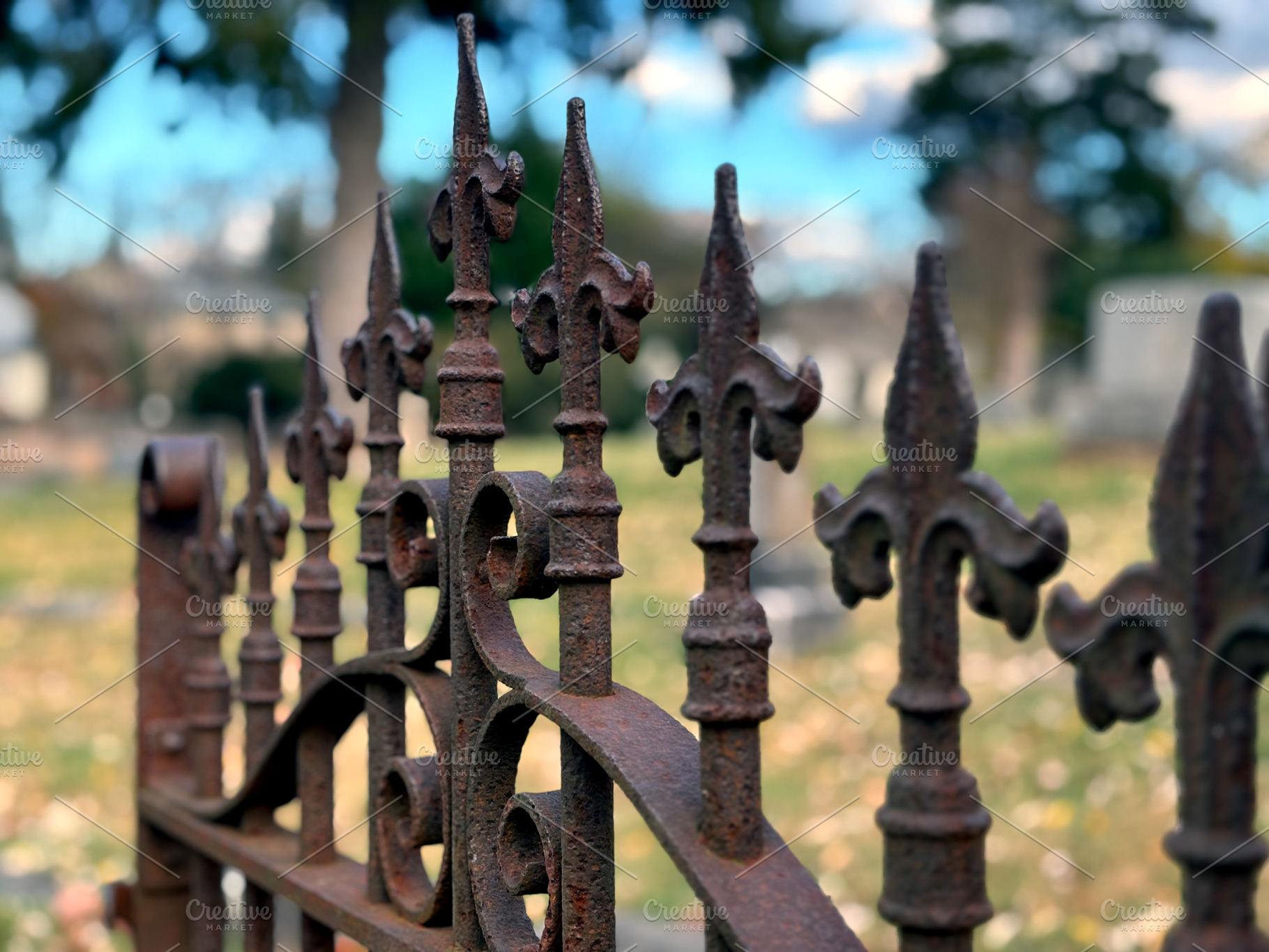 Rusted cemetery gate finials, a Photo by Sick Optix