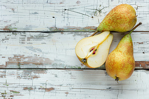 Yellow ripe pears on white wooden table, a Food & Drink Photo by AlyaAnd