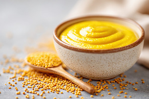 Bowl of smooth yellow mustard, a Food & Drink Photo by AlyaAnd