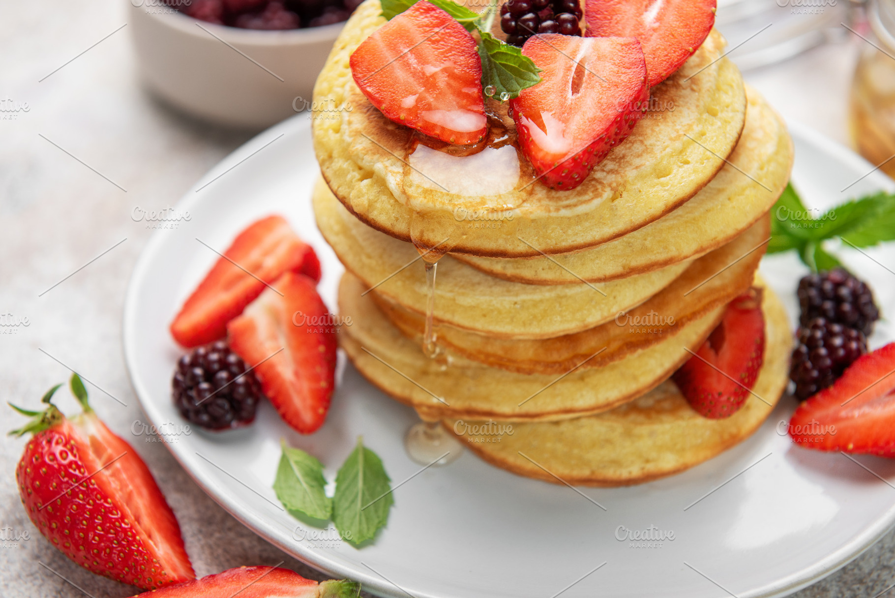 Pancake stack with fresh strawberries, blackberries, and drippin, a Food & Drink Photo by Olena Rudo