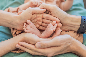 Newborn tiny feet surrounded by, a Person Photo by Elizaveta Galitskaya