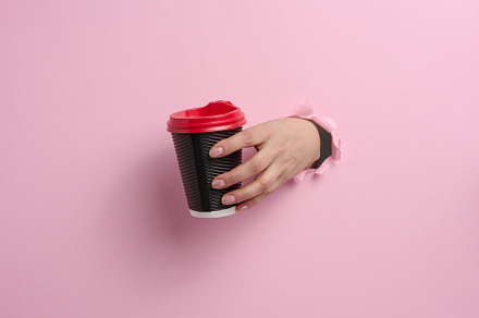 hand holds paper cardboard brown cup for coffee, pink background, a Food & Drink Photo by ndanko