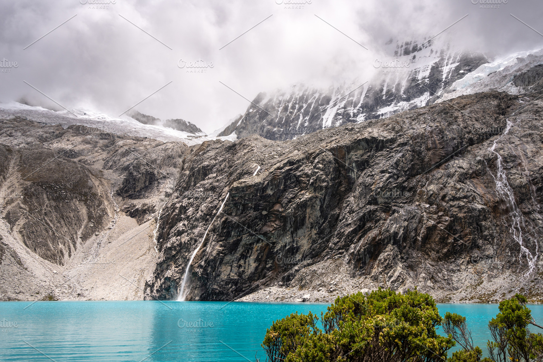 Laguna 69 with turquoise water and snowy mountains in Huaraz, Pe, a Photo by GoodGoods