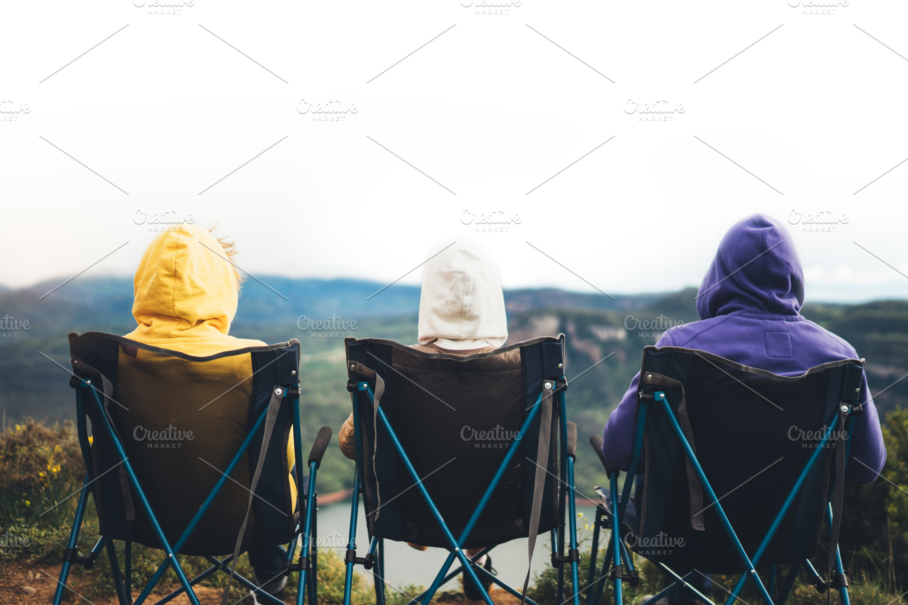 Three friends sit in camping chairs stock photo containing friends and nature, a Person Photo by A_B_C
