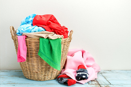 Clothes in a laundry wooden basket 