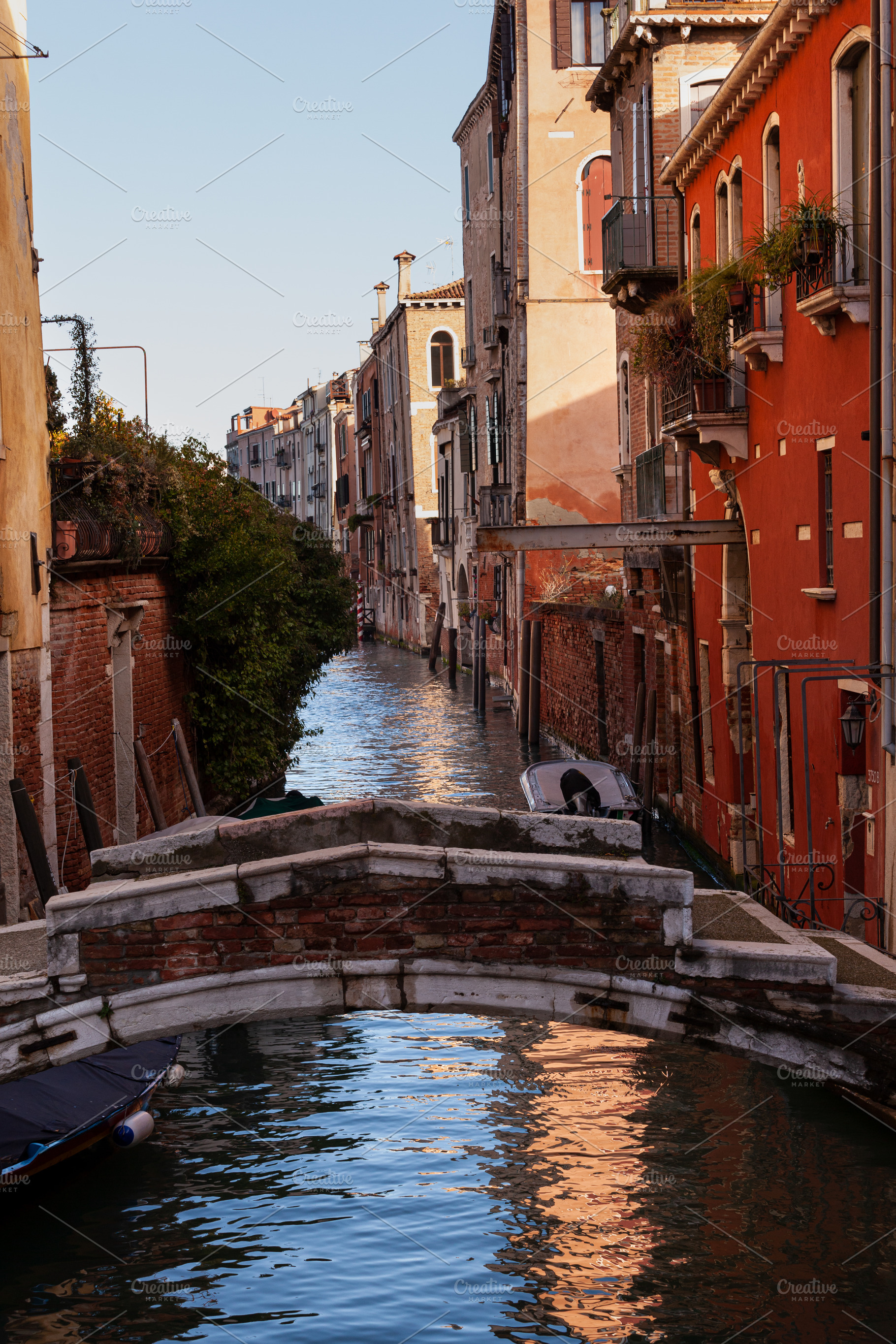 The old bridge made with red bricks on the typical canal in Venice, an Architecture Photo by Bepslabor