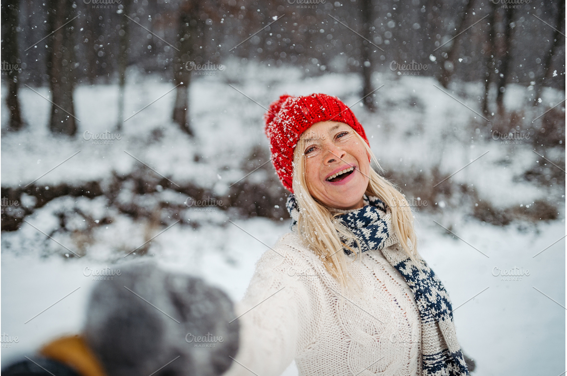 Happy elderly woman smiling outdoors, a Holiday Photo by HalfPoint