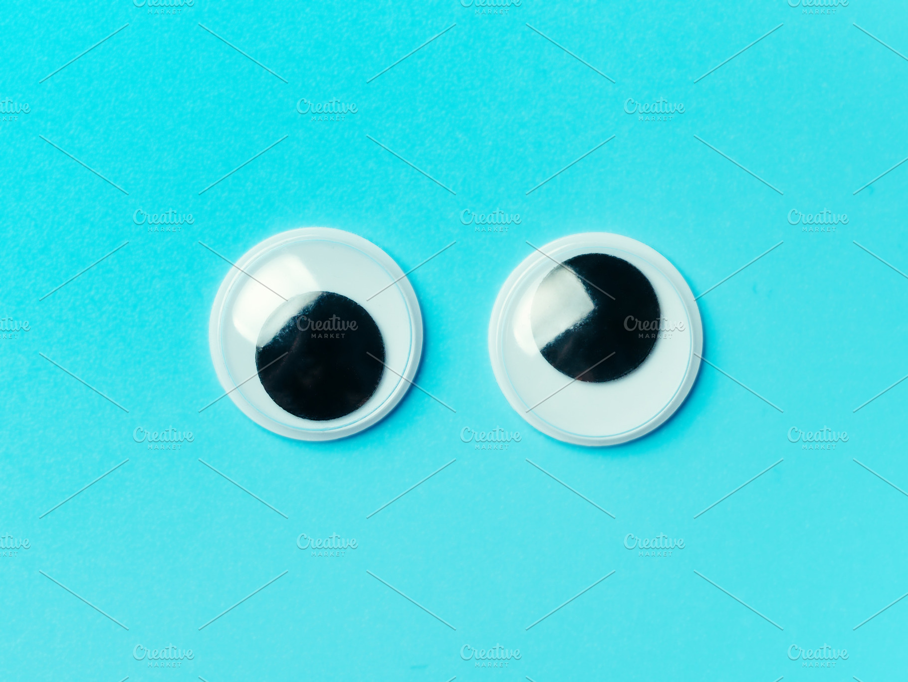 Googly eyes on turquoise background featuring googly eyes, googly, and eyes, a Holiday Photo by Fascinadora