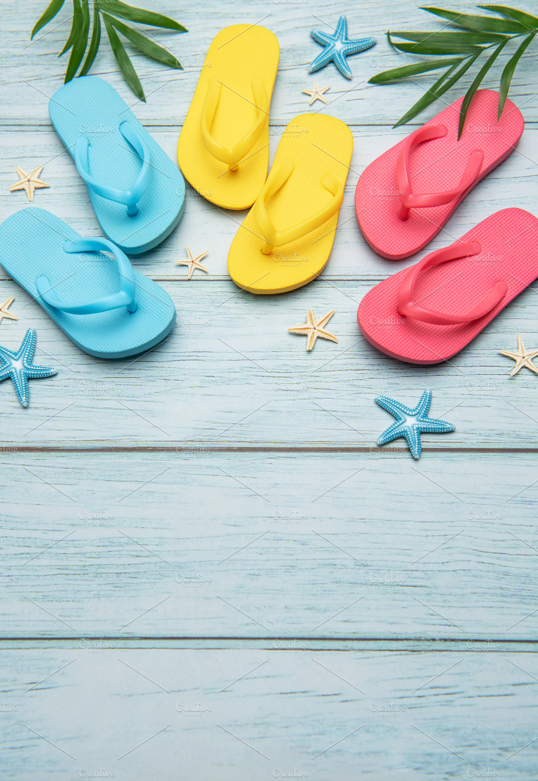 Colorful flip flops and starfish creating summer vacation atmosp, a Holiday Photo by Olena Rudo