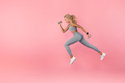 Young Woman Running With Dumbbells Isolated On Studio Background, a Photo by Prostock-Studio (Thumbnail 2 of 2)
