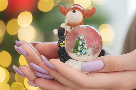 A young girl with a beautiful light purple manicure is holding a, a Holiday Photo by Olena Rudo