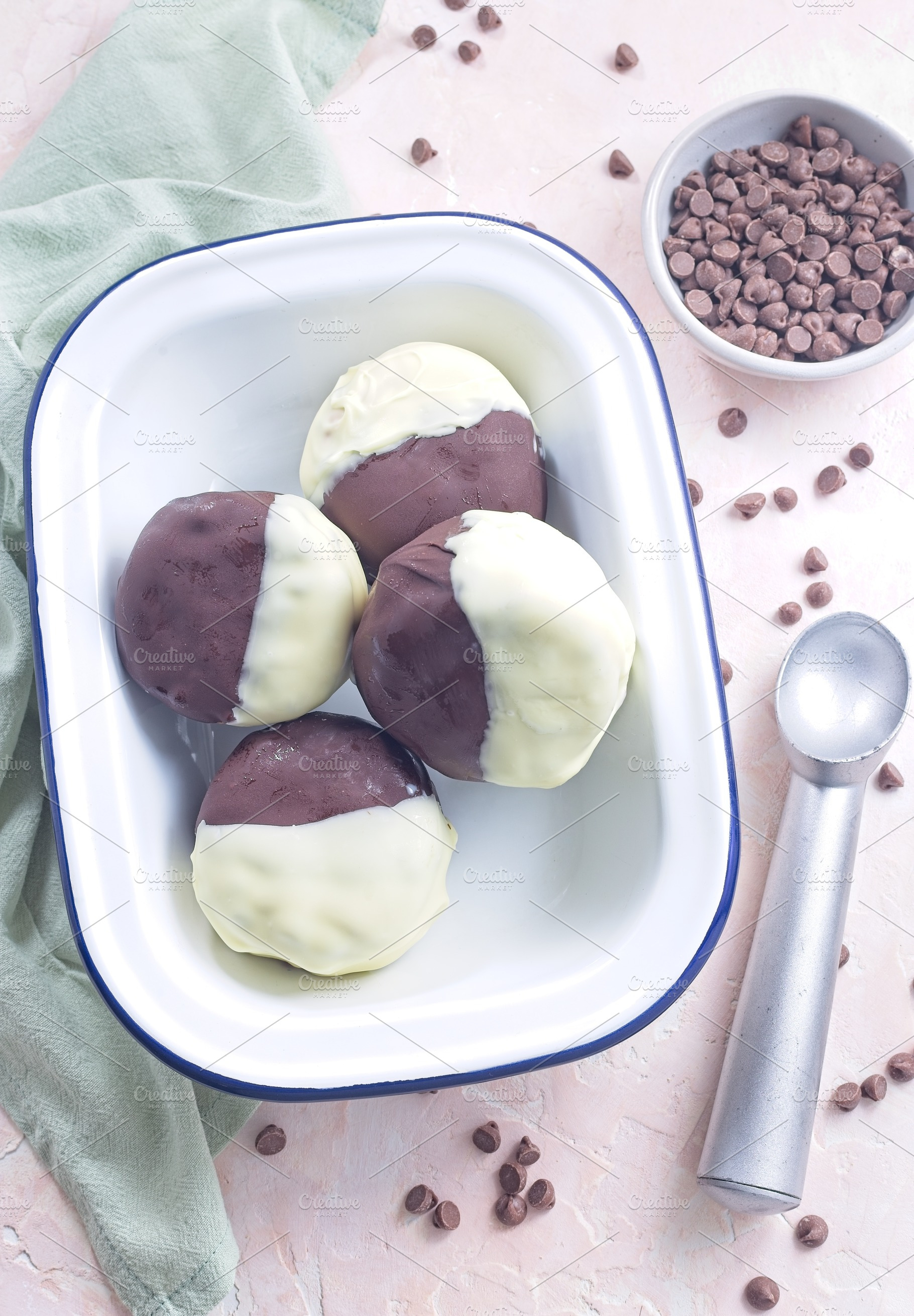 Dark and white chocolate covered ice cream sandwiches, on white plate, vertical, a Food & Drink Photo by iuliia_n