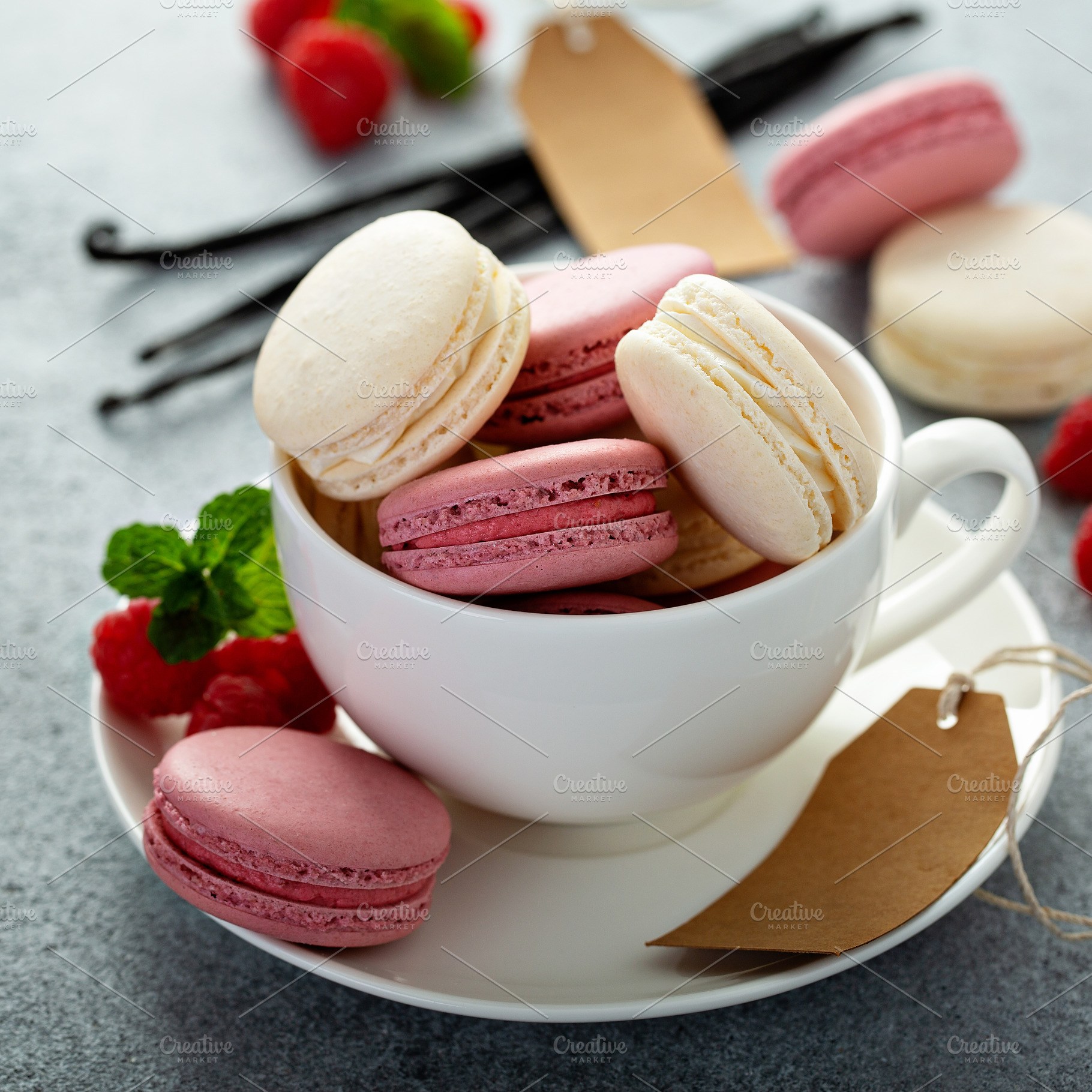 Vanilla and raspberry macarons in a teacup, a Food & Drink Photo by farwasser