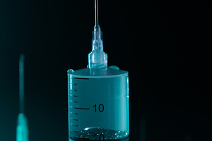 Close-up of Large Medical Syringe and Needle on Dark Background., a Health & Medical Photo by Rohan Photography