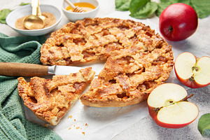 Homemade apple pie with ingredients on concrete background, a Food & Drink Photo by Olena Rudo