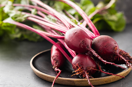 Beet beetroot bunch on wooden plate featuring beet, beetroot, and root, a Food & Drink Photo by Harahliad