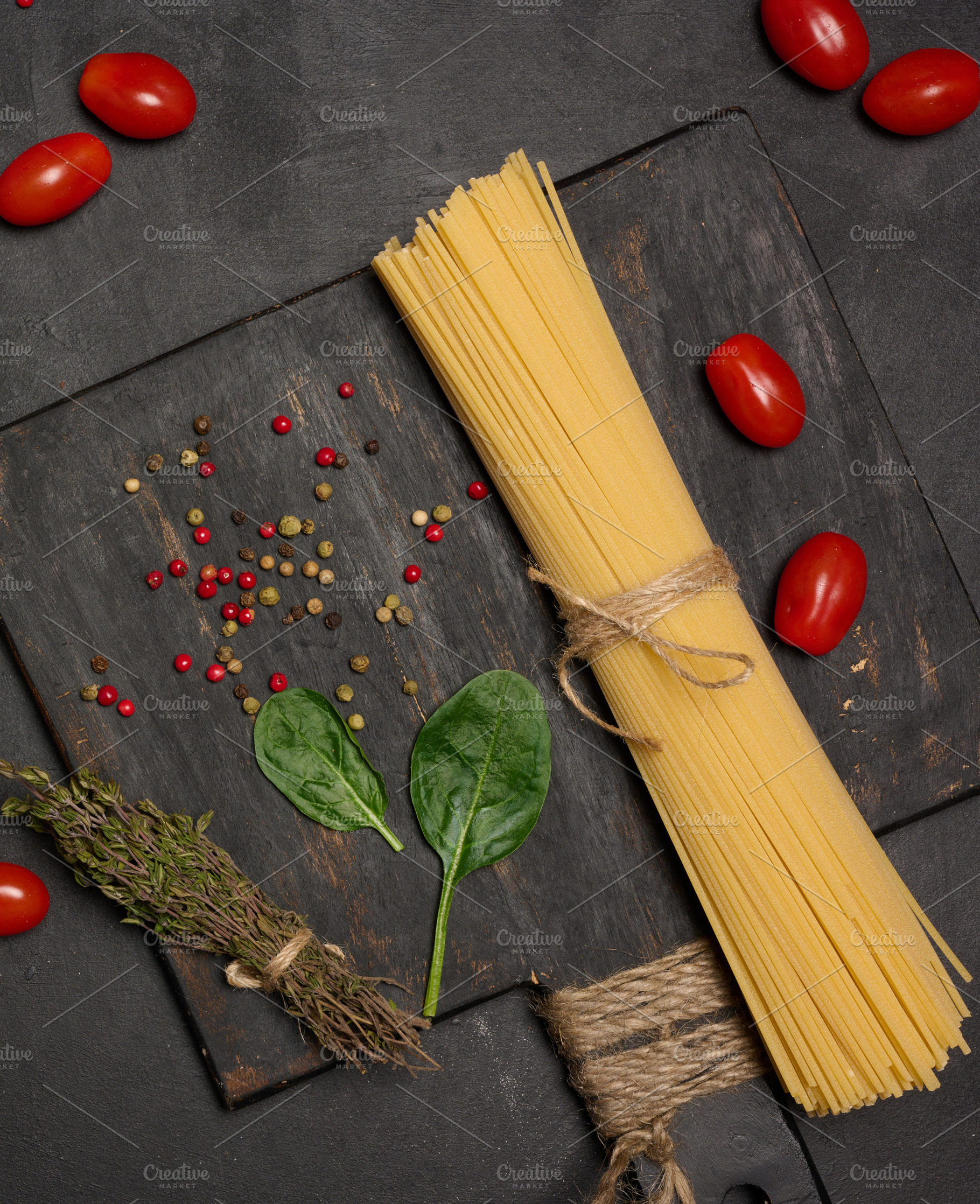 Flat lay of fresh spinach, cherry tomatoes, spaghetti, and spice, a Food & Drink Photo by ndanko