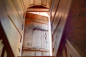 Wooden stairs leading to door with warm light, an Architecture Photo by DanFLCreativo