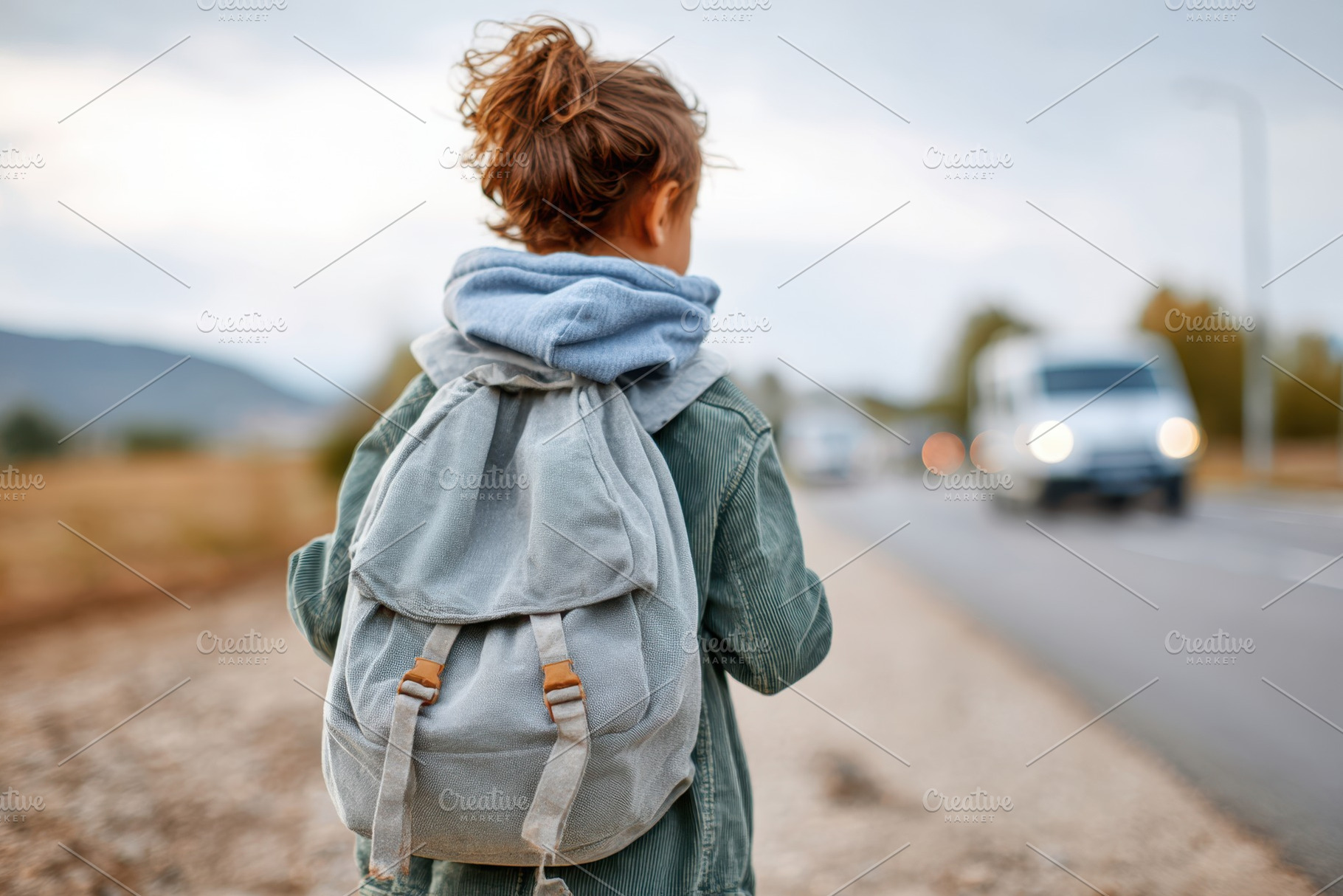 Young girl with backpack by the roadside, a Person Photo by AlyaAnd