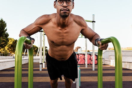 Man doing incline push-ups on parall, a Sports & Recreation Photo by Perpis