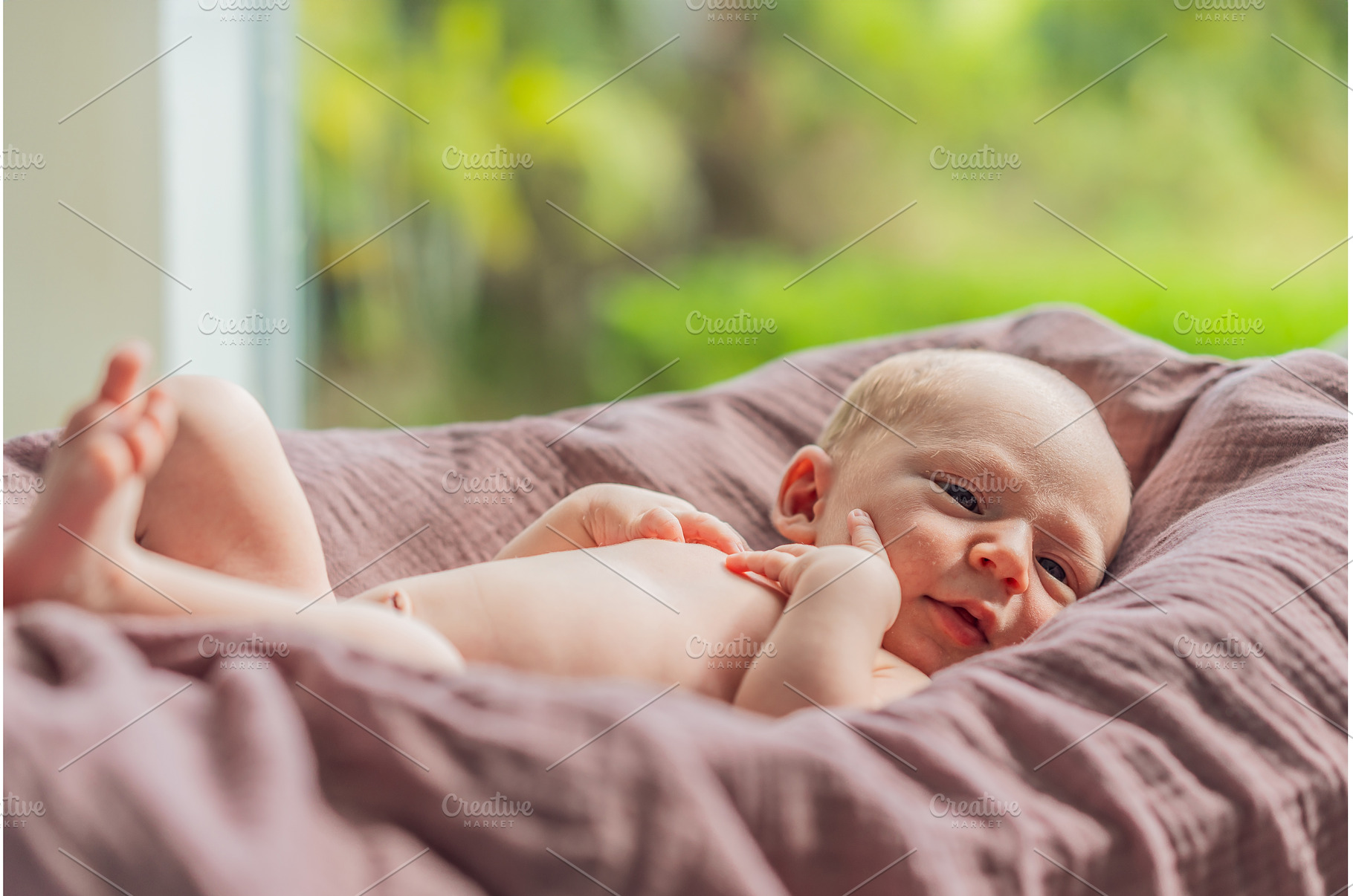 A newborn lies in his cozy cocoon on, a Person Photo by Elizaveta Galitskaya