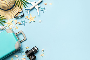 Travel accessories creating a frame on light blue background wit, a Holiday Photo by Olena Rudo
