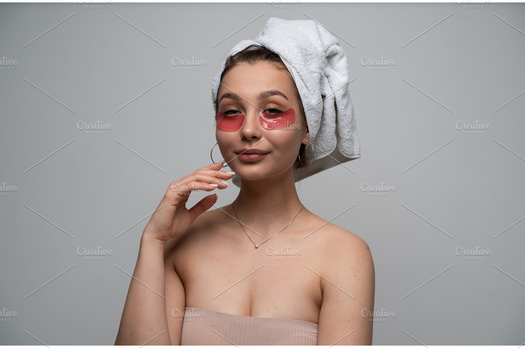 Young woman applying red eye patches, a Health & Medical Photo by volodymyrshtun13795