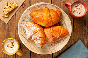 Delicious freshly baked croissants and cappuccino enjoying breakfast, a Food & Drink Photo by Antonio Gravante Market