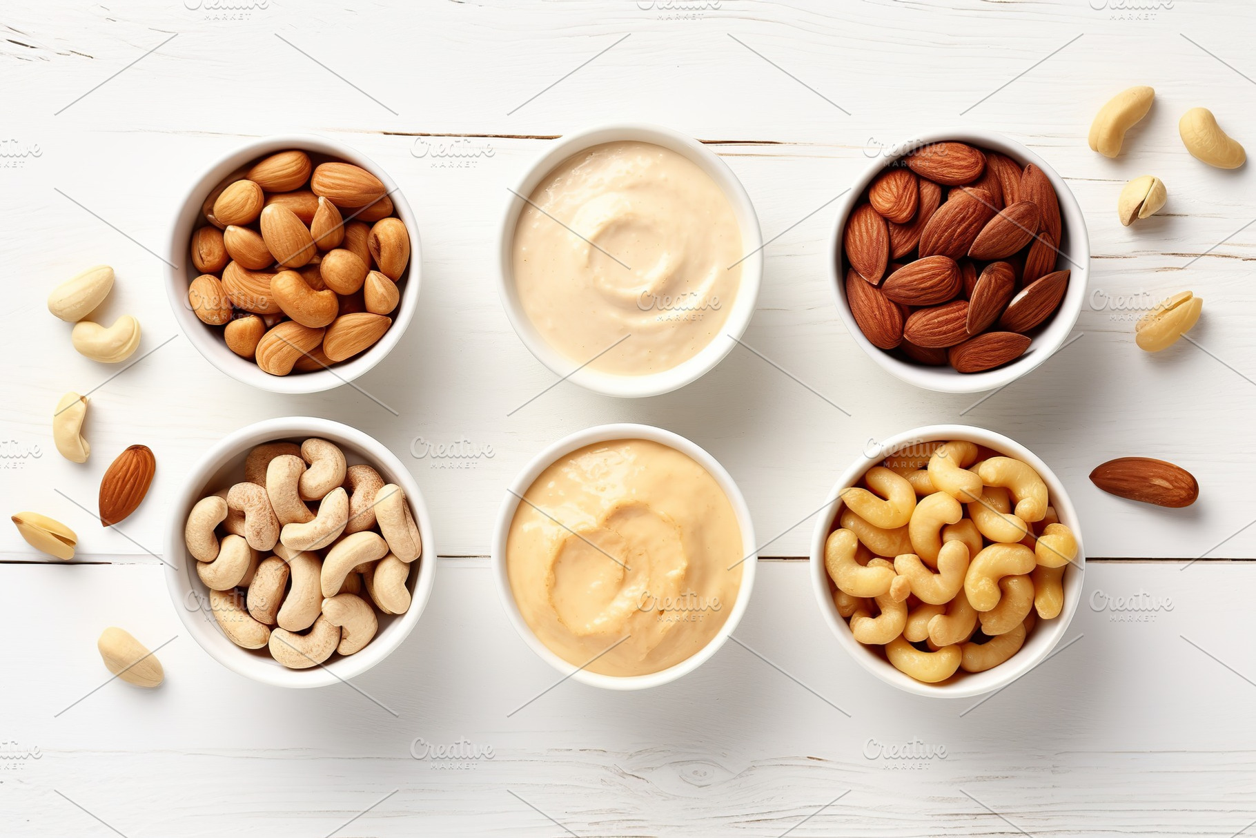 Bowls of hazelnut, cashew and almonds butter on wooden background, a Food & Drink Photo by AlyaAnd