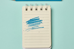 Spiral-bound lined notepad with a blue scribbled stroke and a bl, a School & Education Photo by ndanko