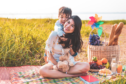 Beautiful Asian mother and son doing picnic and in Easter summer, a Person Photo by Ministocker