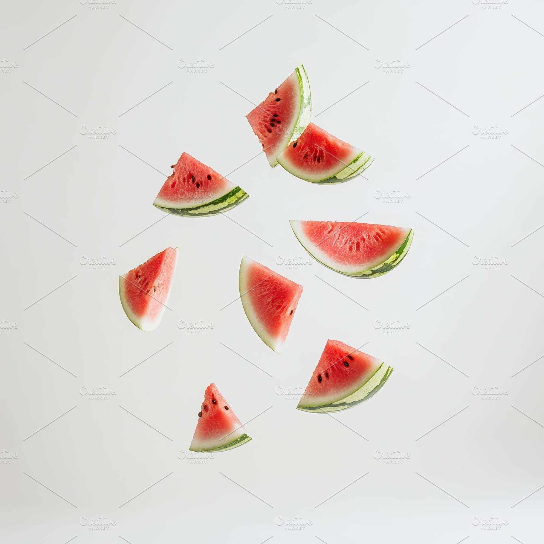 Watermelon slices falling white back, a Food & Drink Photo by Pixeness Studio