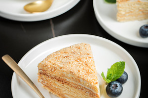 Medovik. Honey cake made from honey cakes with whipped sour cream, decorated wi