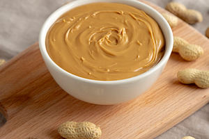 Organic Peanut Butter in a Bowl, side view., a Food & Drink Photo by LiudmylaChuhunova