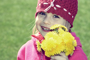 Little girl with yellow flowers, a Person Photo by BOOCYS