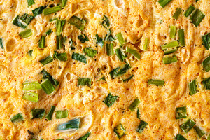 Macro shot capturing the texture of a homemade omelet cooked with fresh green o, a Food & Drink Photo by Eugene_Photo