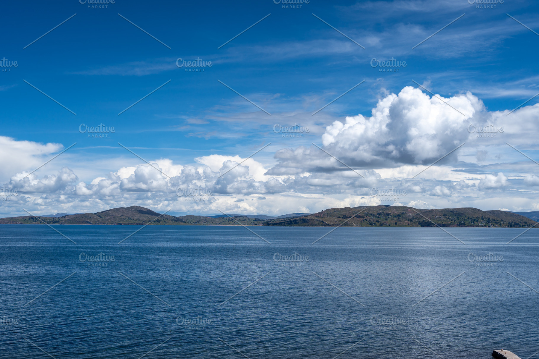 View of Lake Titicaca from Llachon with distant islands and hill, a Photo by GoodGoods