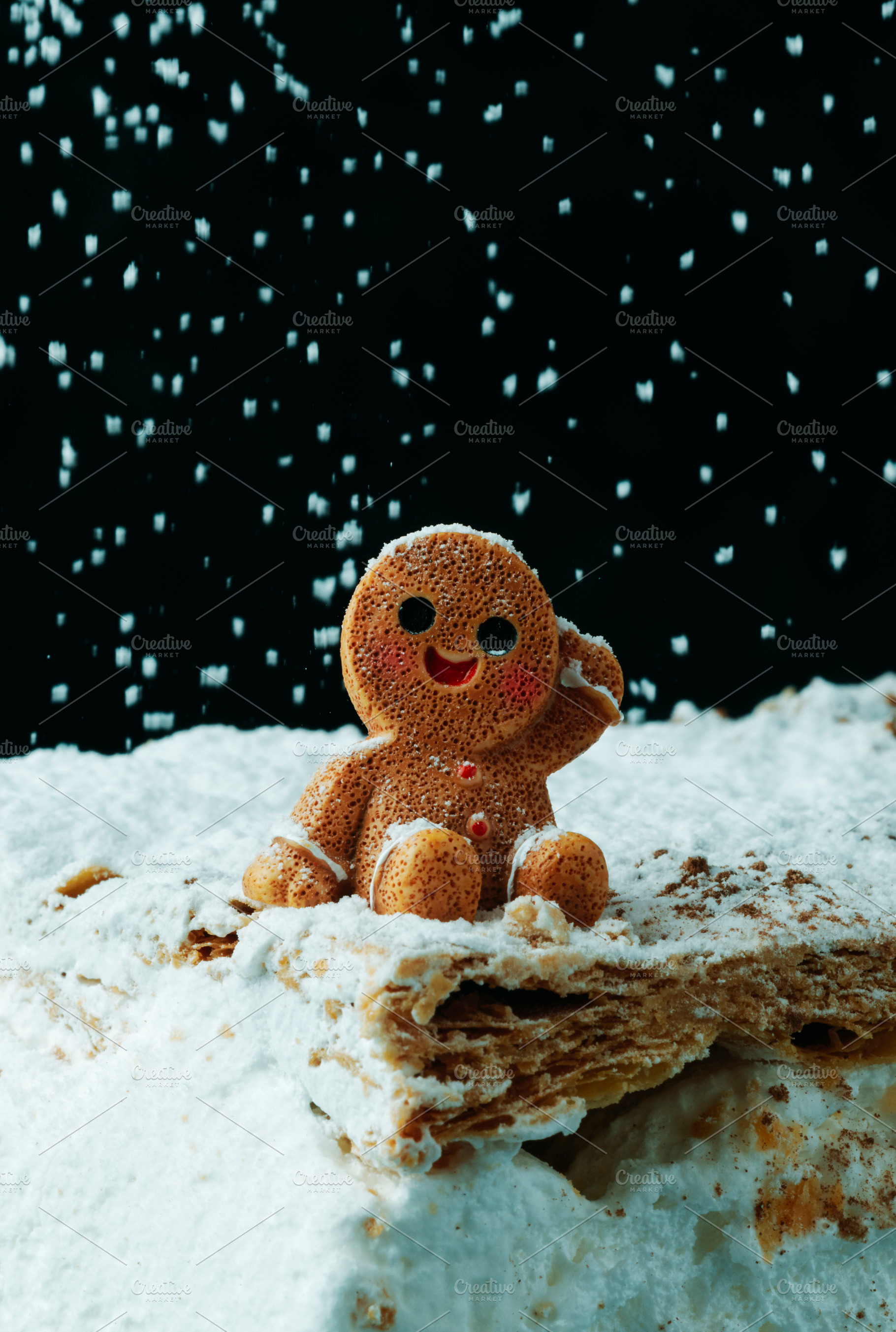 gingerbread man resting under snowfall, a Photo by Nito